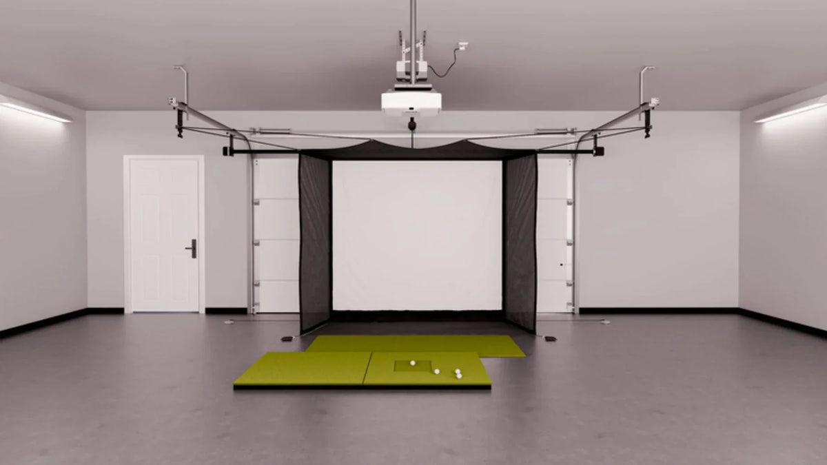 Home garage golf simulator with a retractable impact screen, hitting mats and a ceiling-mounted projector, an alternative to a golf simulator near me